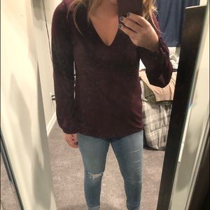 Maroon blouse with laced cut out back.